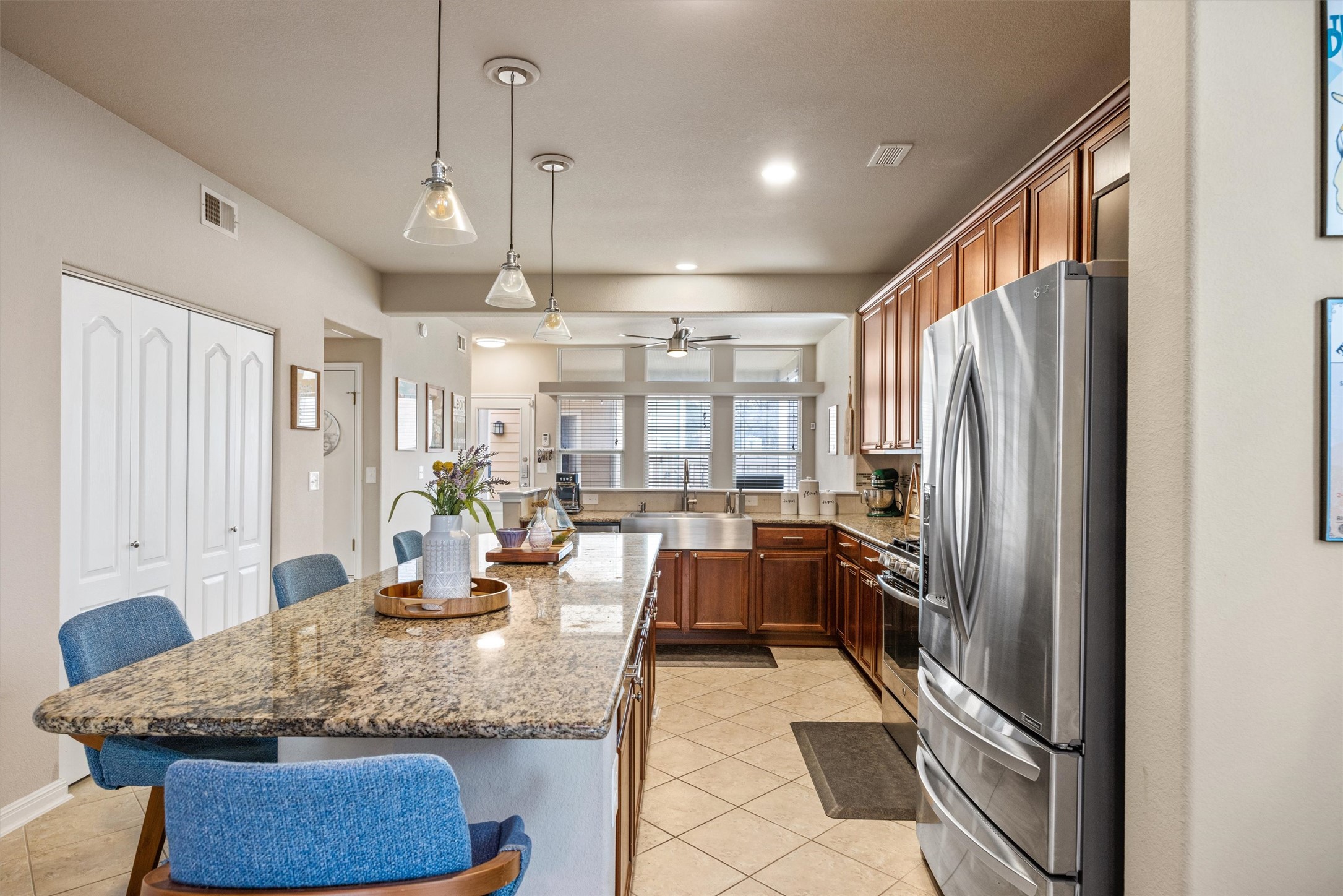 1117 Nevarez Kyle, TX 78640 - Photo 8 of 32 a kitchen with stainless steel appliances granite countertop a refrigerator and a sink