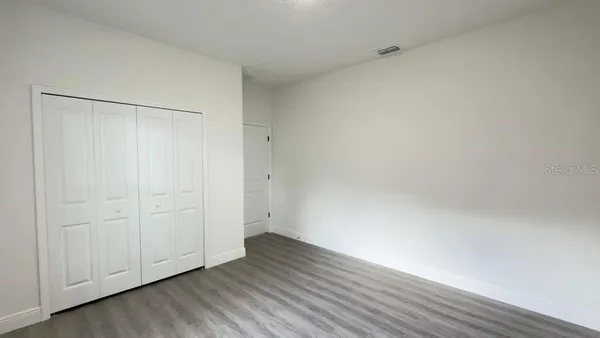 a view of an empty room and wooden floor