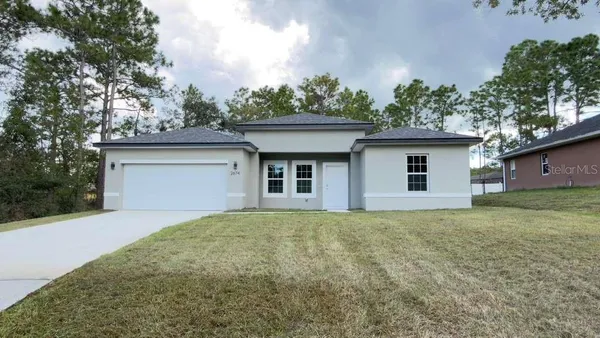 a house that has a tree in front of it