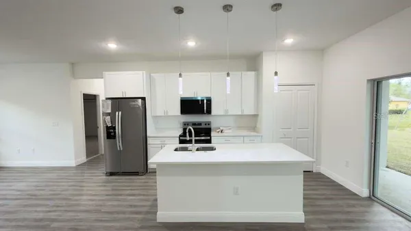 a kitchen with stainless steel appliances a refrigerator stove microwave and cabinets