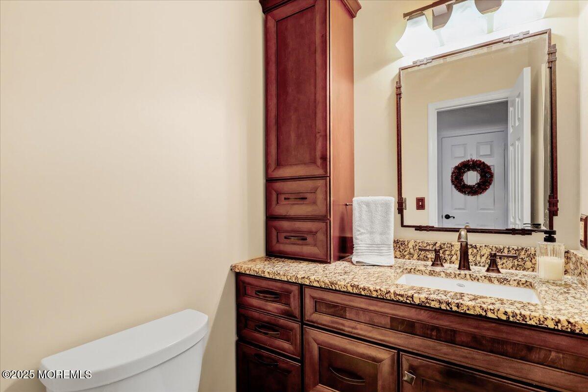 7 Hawk Court Howell, NJ 07731 - Photo 14 of 32 a bathroom with a granite countertop sink a toilet and mirror