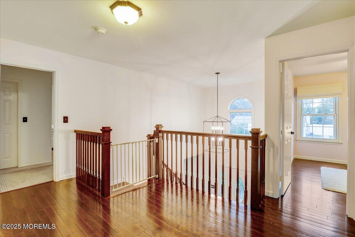 7 Hawk Court Howell, NJ 07731 - Photo 16 of 32 a view of a hallway with wooden floor and windows