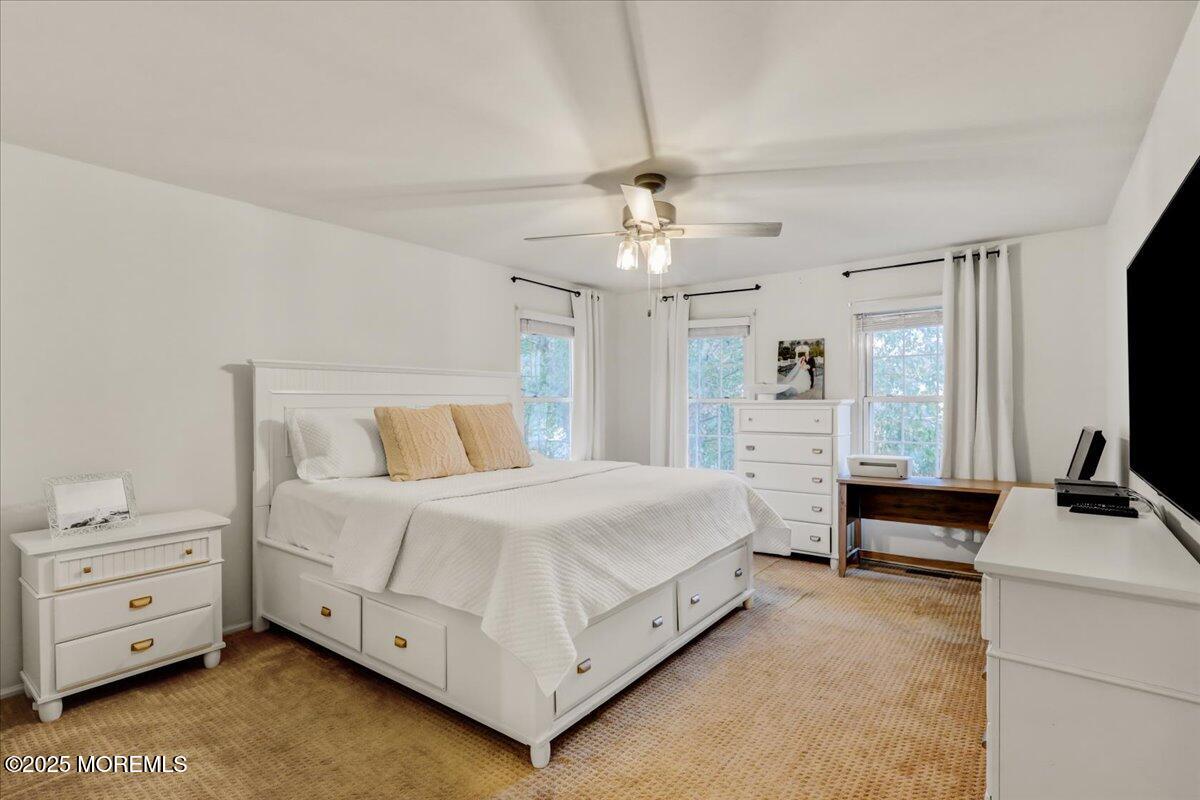 7 Hawk Court Howell, NJ 07731 - Photo 18 of 32 a bedroom with a bed and a flat tv screen on dresser