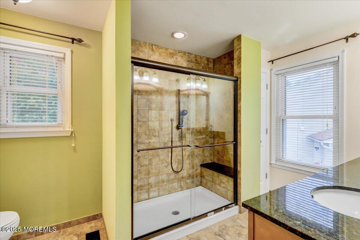 7 Hawk Court Howell, NJ 07731 - Photo 19 of 32 a bathroom with a glass shower door