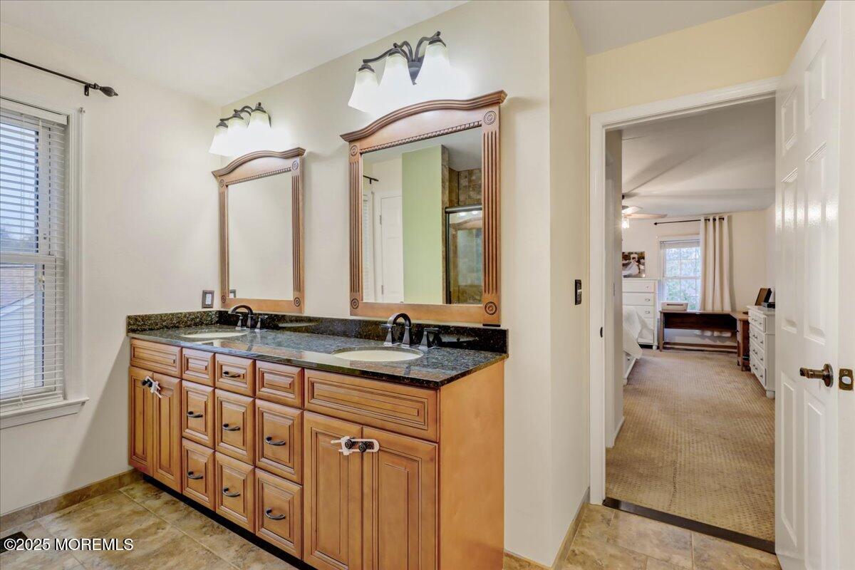 7 Hawk Court Howell, NJ 07731 - Photo 20 of 32 a spacious bathroom with a granite countertop sink and a mirror