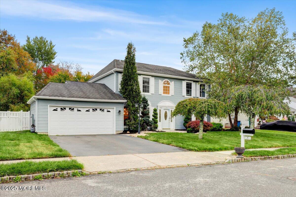 7 Hawk Court Howell, NJ 07731 - Photo 2 of 32 a front view of a house with a yard and garage