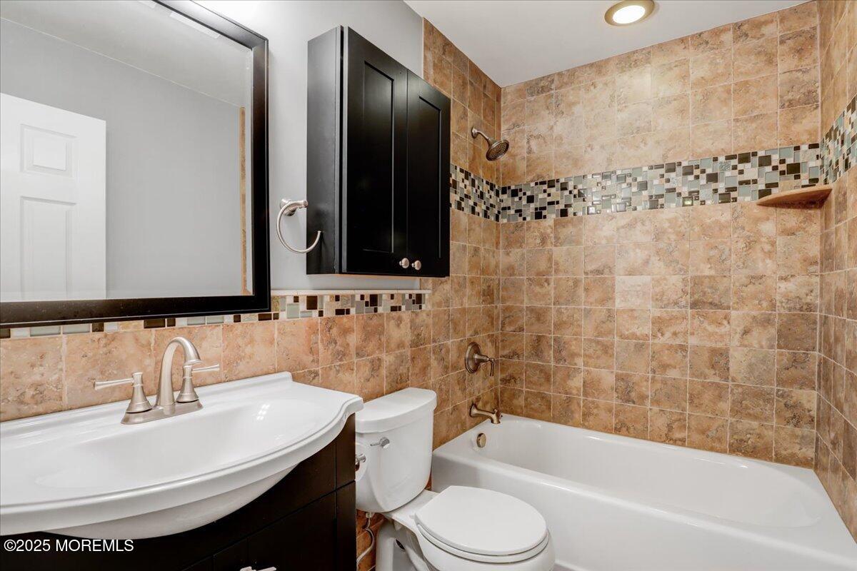 7 Hawk Court Howell, NJ 07731 - Photo 23 of 32 a bathroom with a sink a toilet and shower