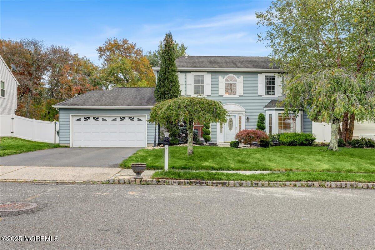 7 Hawk Court Howell, NJ 07731 - Photo 3 of 32 a front view of a house with a yard and garage