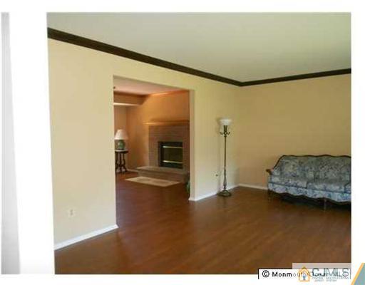 619 Lloyd Road Aberdeen, NJ 07747 - Photo 7 of 8 a living room with furniture and a wooden floor