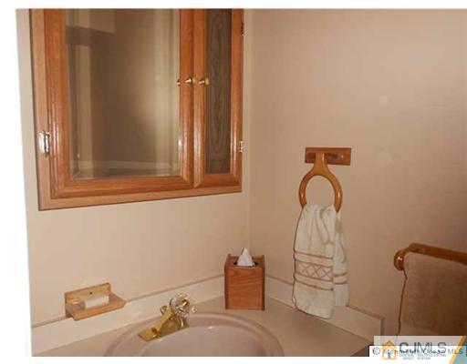 619 Lloyd Road Aberdeen, NJ 07747 - Photo 8 of 8 a bathroom with a sink and a mirror