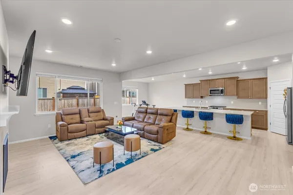 a living room with furniture white walls and kitchen view