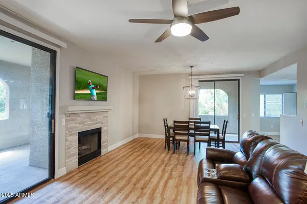 a living room with furniture fireplace and a window