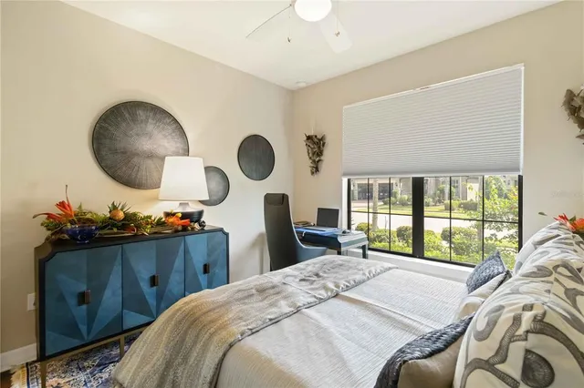 a bedroom with a bed and a large window