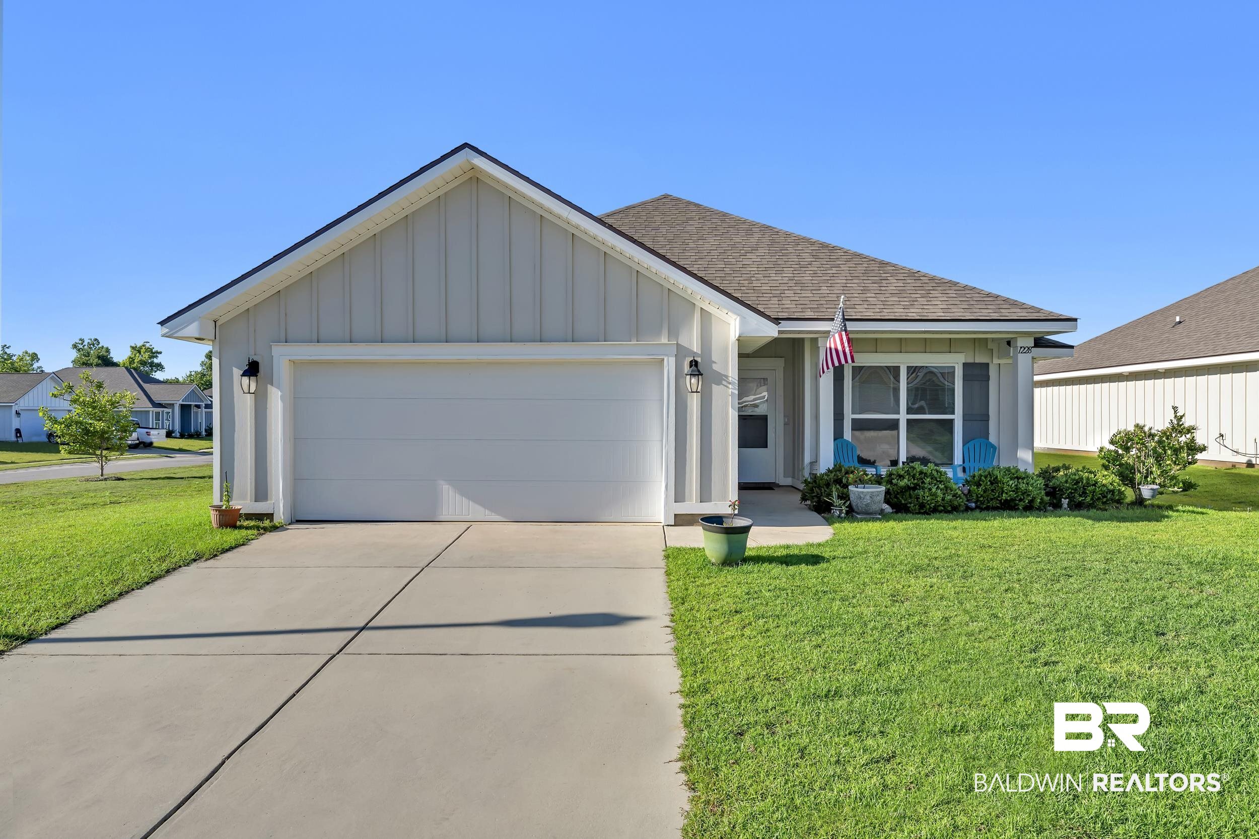 1228 Caper Avenue Foley, AL 36535 - Photo 1 of 54 Single-story residence featuring light-colored vertical siding and a dark shingle roof