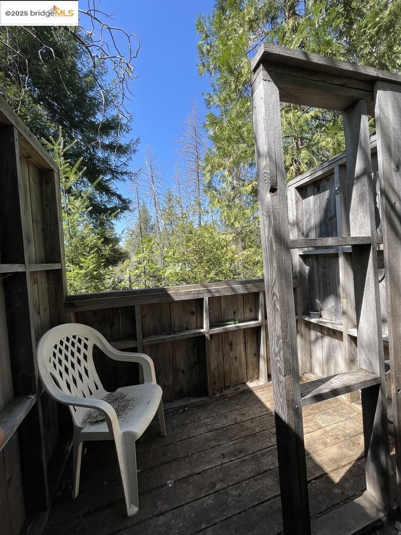 15003 Alleghany Road North San Juan, CA 95960 - Photo 9 of 27 a balcony with wooden floor table and chairs