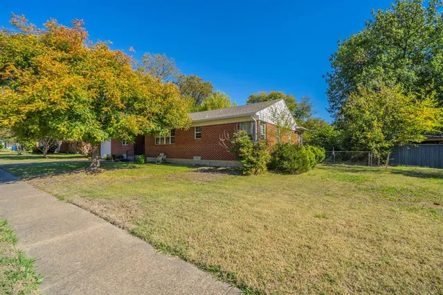 a front view of house with yard and trees