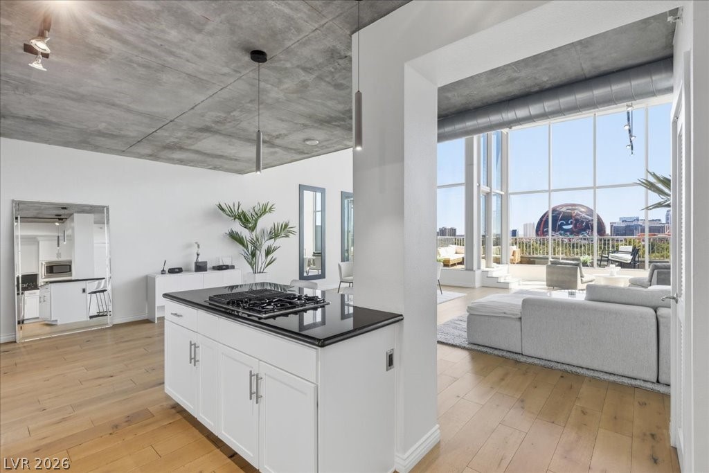 360 East Desert Inn Road, Unit 604 Las Vegas, NV 89109 - Photo 17 of 28 Floor-to-ceiling windows illuminate this open-concept urban dwelling, offering expansive city views.