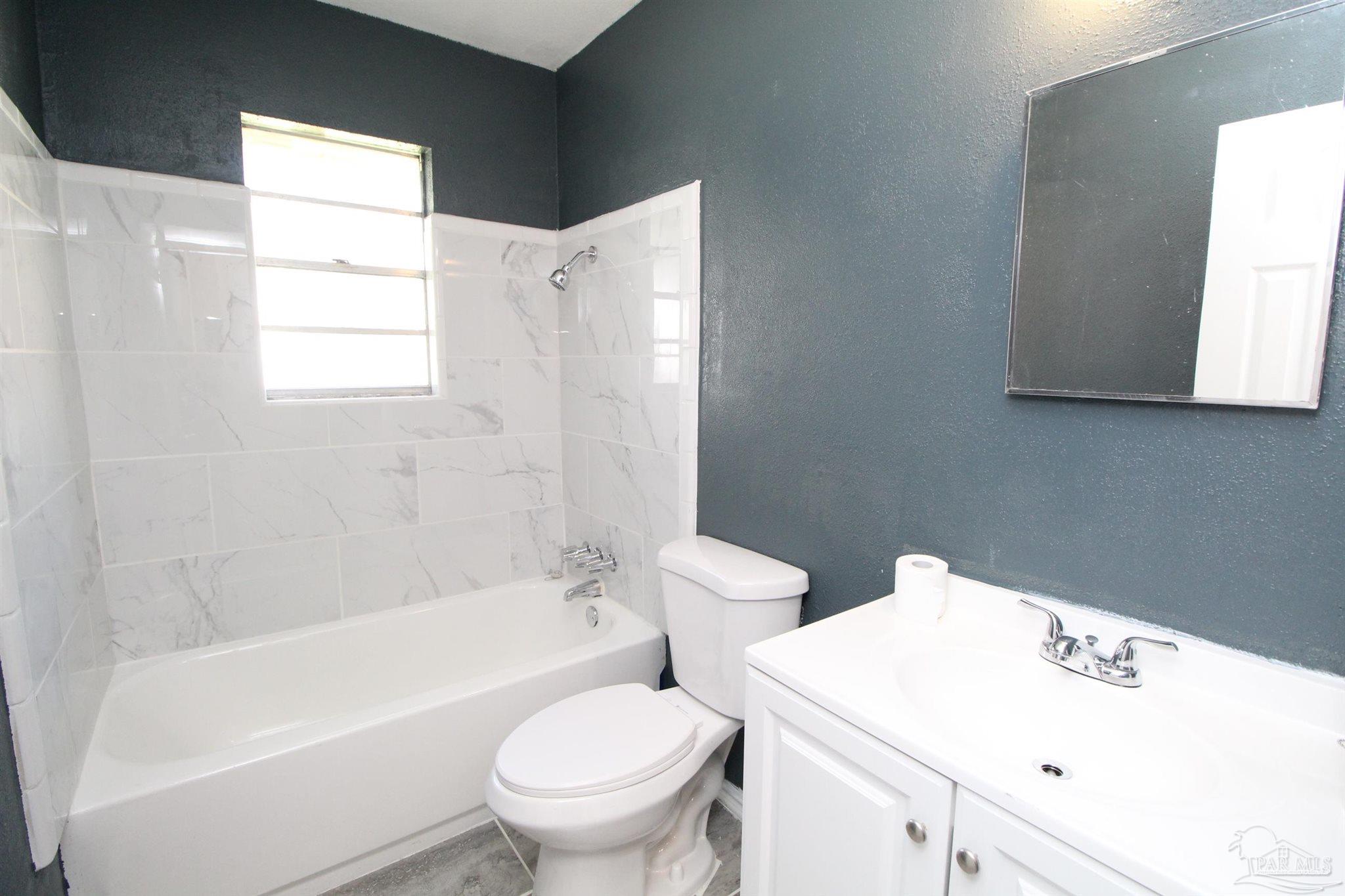 6620 Applegate Street Milton, FL 32570 - Photo 10 of 12 a bathroom with a sink a toilet and a bathtub