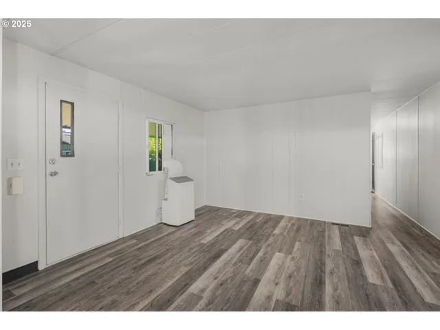 a view of an empty room and wooden floor