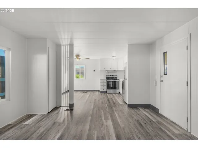 a view of kitchen with hardwood floor and electronic appliances