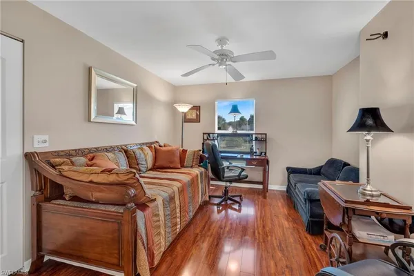 a living room with furniture and a wooden floor