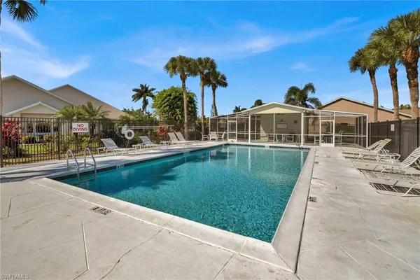 a view of a patio with a table and chairs under an umbrella