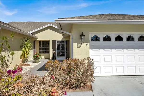 a front view of a house with a yard and balcony