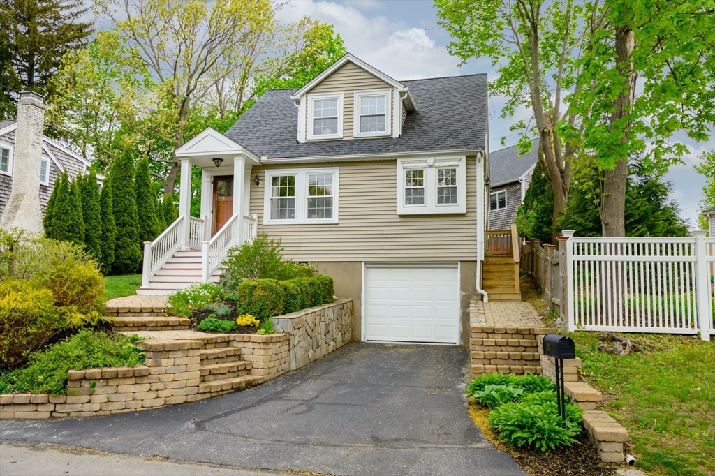 a front view of a house with a garden