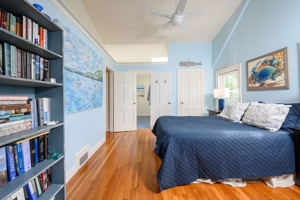 21 Rice Road Hingham, MA 02043 - Photo 18 of 40 a bedroom with a bed a book shelf and a book shelf