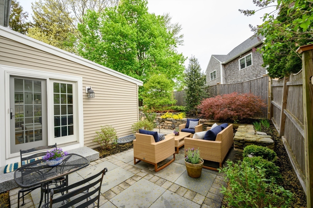 21 Rice Road Hingham, MA 02043 - Photo 29 of 40 a backyard of a house with fountain table and chairs