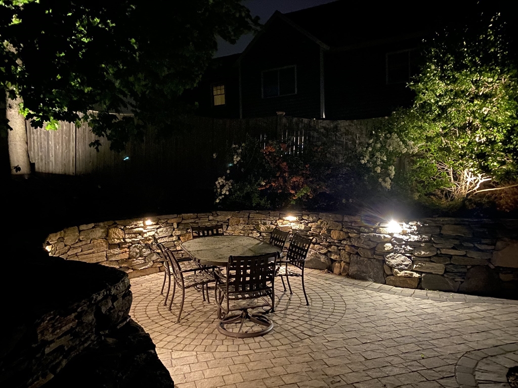 21 Rice Road Hingham, MA 02043 - Photo 32 of 40 a view of a patio with table and chairs with wooden fence