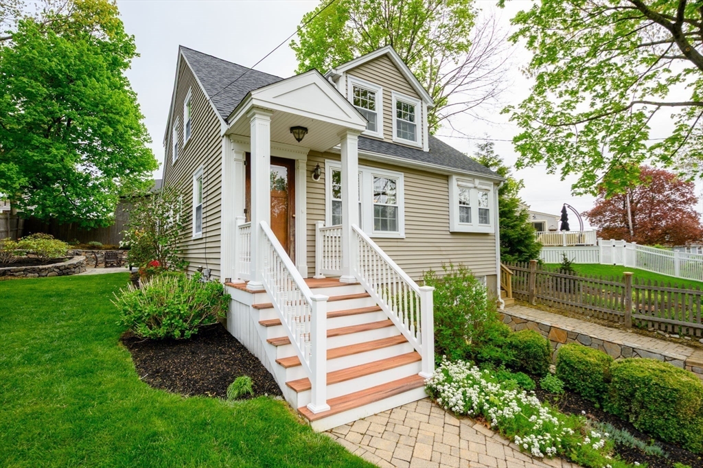 21 Rice Road Hingham, MA 02043 - Photo 33 of 40 a view of a white house with a yard and plants