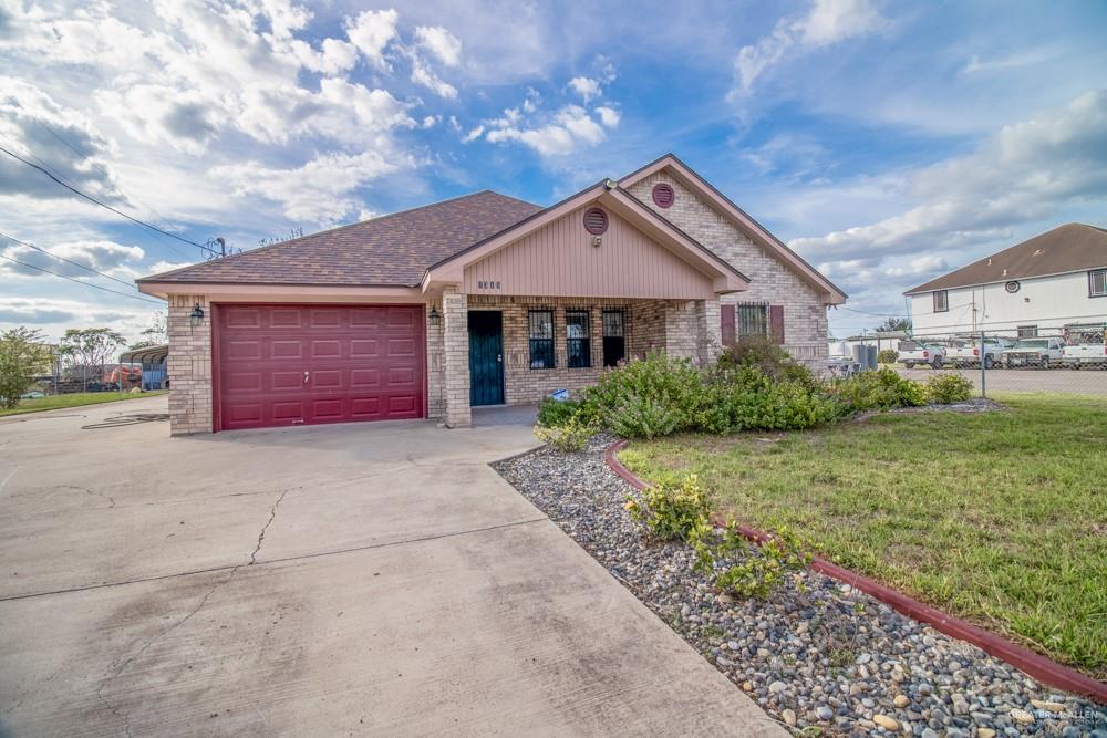 1315 North Tower Road Alamo, TX 78516 - Photo 1 of 1 a front view of a house with a yard and garage