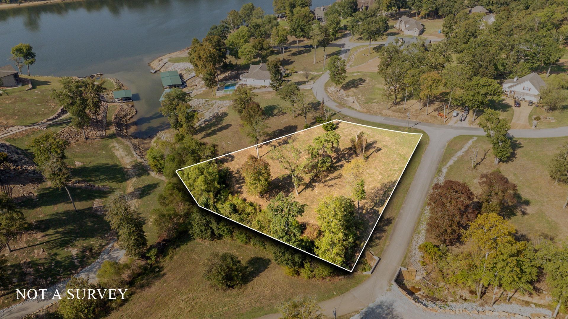 Aerial view of property's location with property boundaries highlighted and a nearby body of water