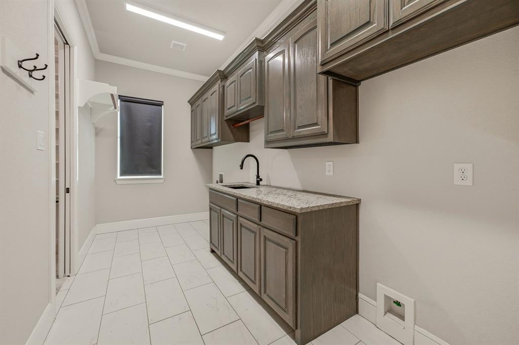 9503 Bellechase Road Granbury, TX 76049 - Photo 23 of 40 a kitchen with a sink and cabinets