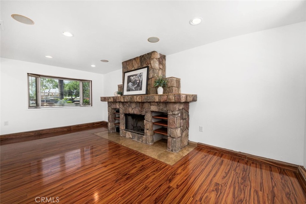1238 North Studebaker Road Long Beach, CA 90815 - Photo 16 of 47 a view of a livingroom with wooden floor and a fireplace