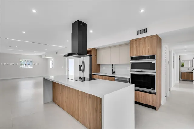 a kitchen with a sink a stove and cabinets