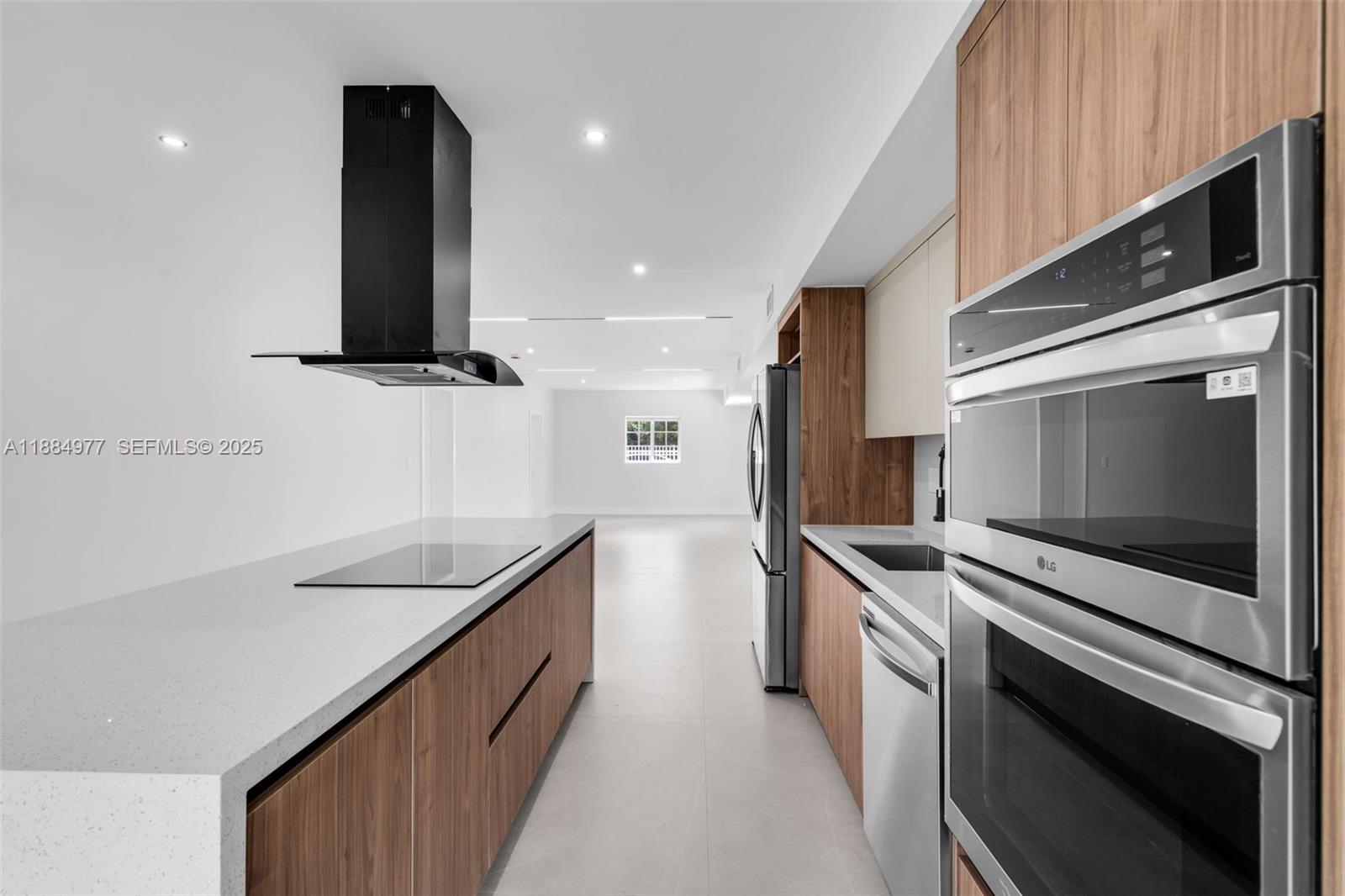 323 Northwest 104th Terrace Miami, FL 33150 - Photo 7 of 30 a kitchen with stainless steel appliances sink and microwave