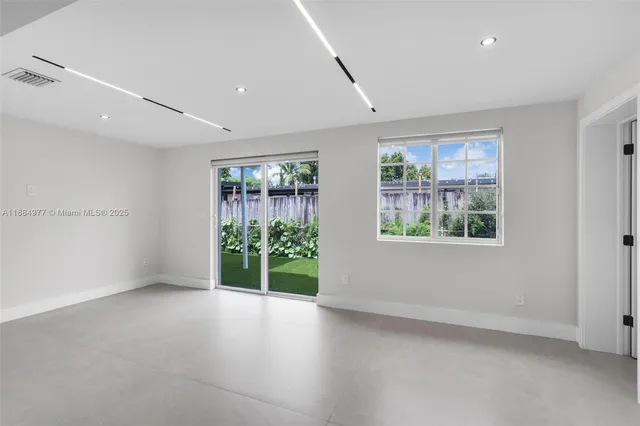 an empty room with windows and view