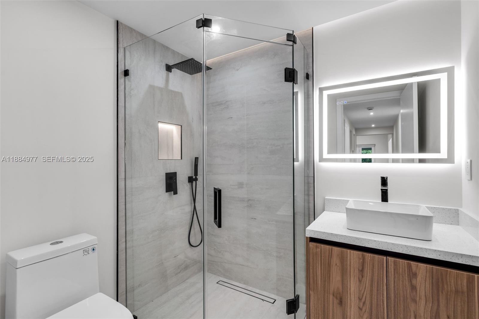 323 Northwest 104th Terrace Miami, FL 33150 - Photo 9 of 30 a bathroom with a sink toilet a mirror and shower