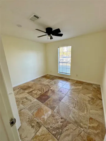 a view of a big room with wooden floor and windows in a room