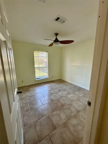 a view of an empty room and a window