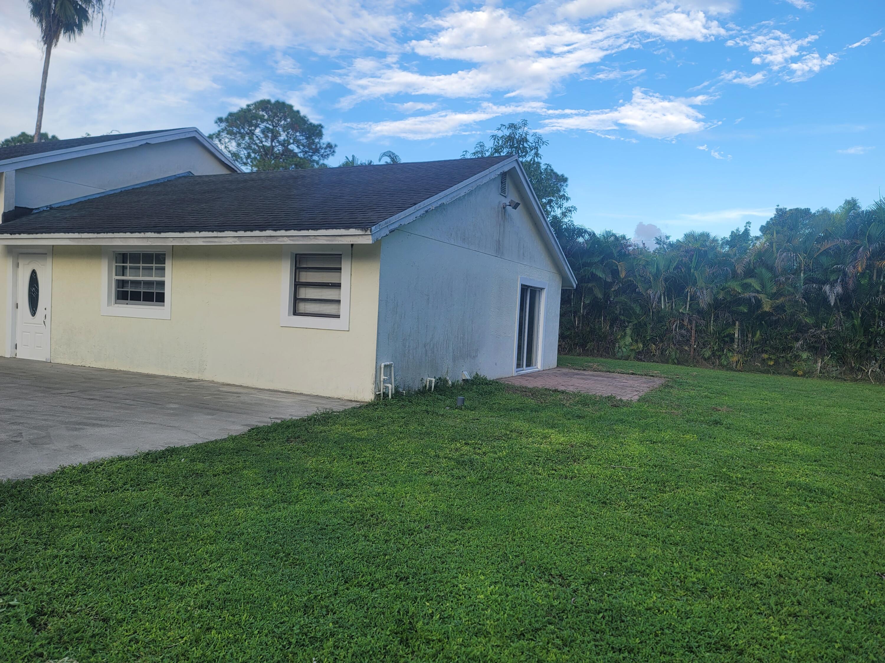 15664 N Road, Unit A Loxahatchee Groves, FL 33470 - Photo 3 of 16 a view of an house with backyard