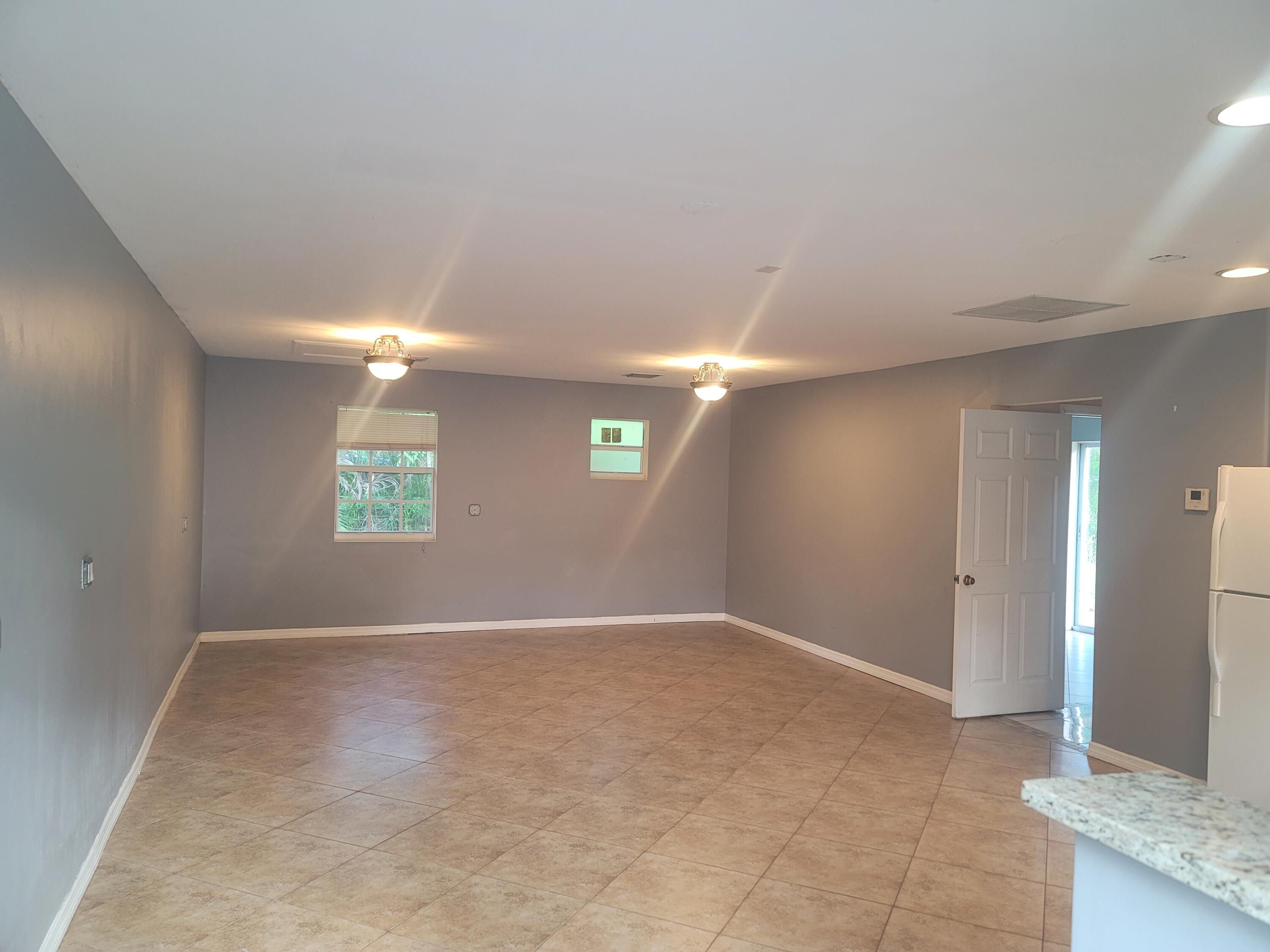 15664 N Road, Unit A Loxahatchee Groves, FL 33470 - Photo 7 of 16 an empty room with windows