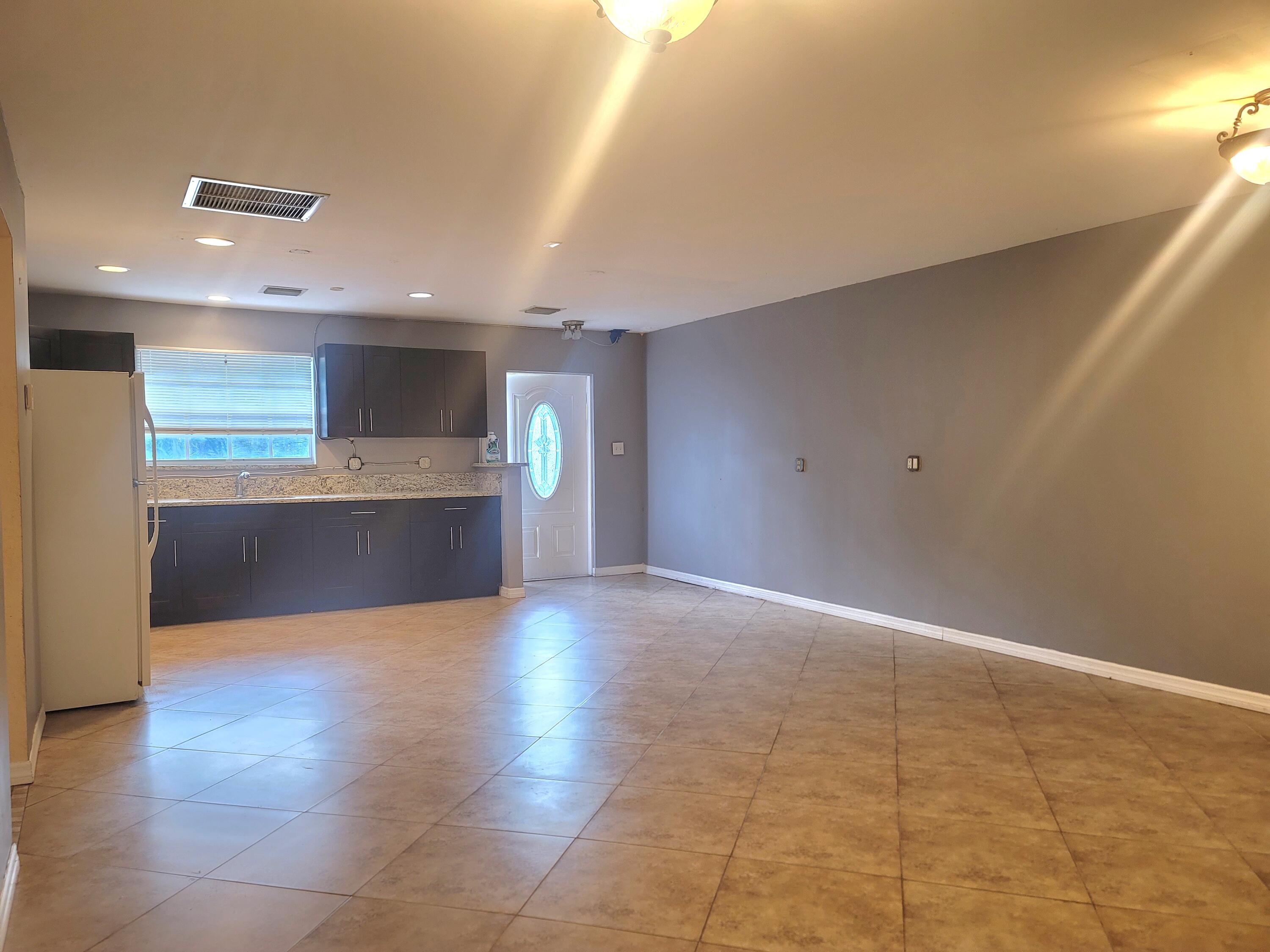 15664 N Road, Unit A Loxahatchee Groves, FL 33470 - Photo 8 of 16 a view of an empty room with a kitchen