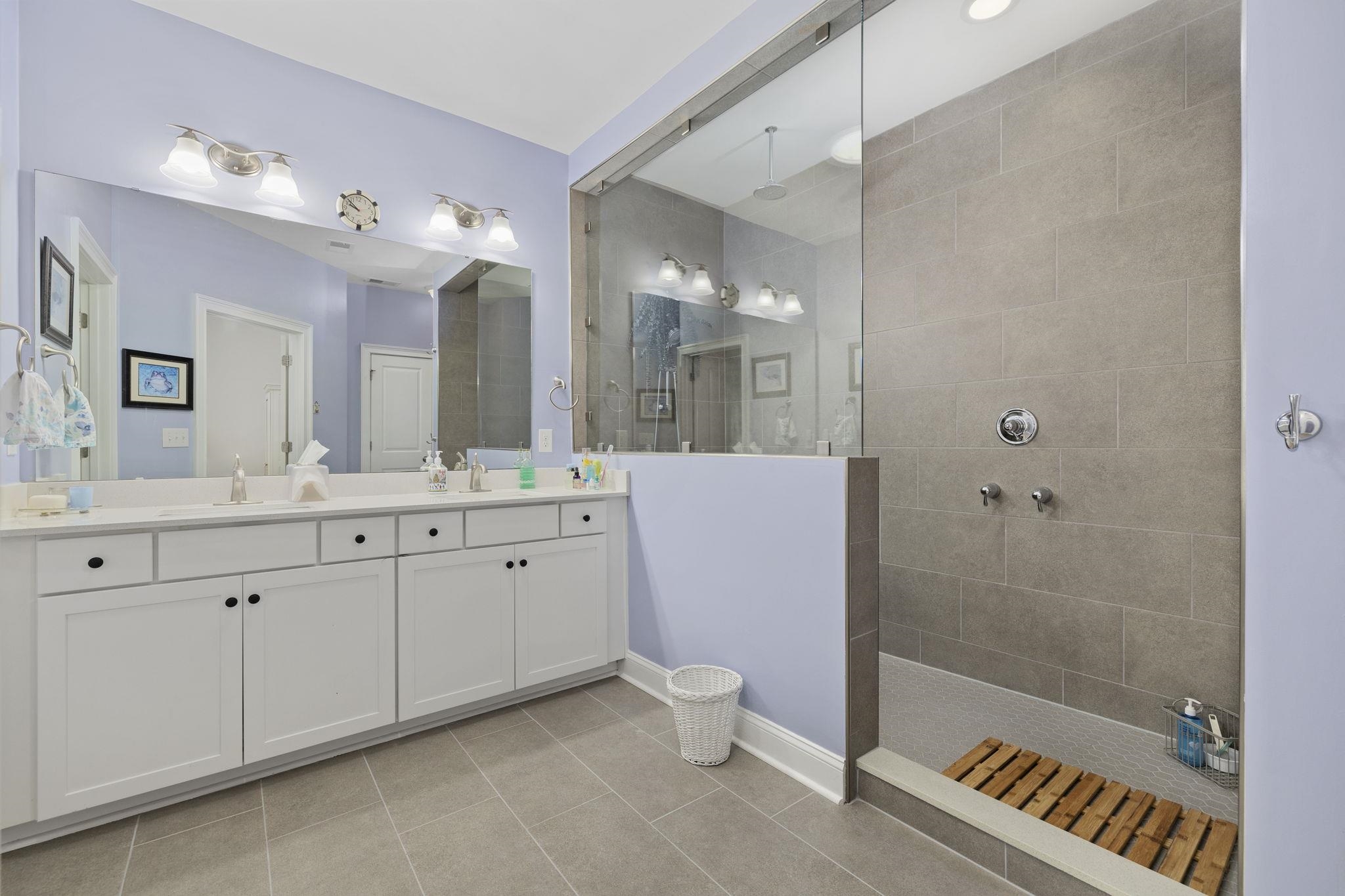 1704 Edgewood Drive Myrtle Beach, SC 29577 - Photo 17 of 40 Bathroom featuring walk in shower, double vanity, and light tile patterned floors