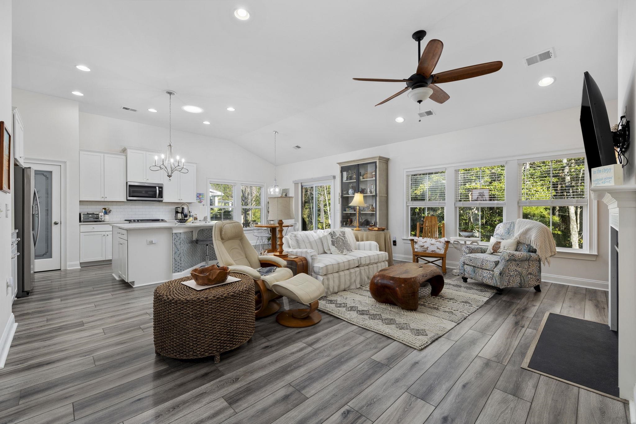 1704 Edgewood Drive Myrtle Beach, SC 29577 - Photo 7 of 40 Living room featuring vaulted ceiling, a chandelier, recessed lighting, a fireplace, and light wood-style flooring