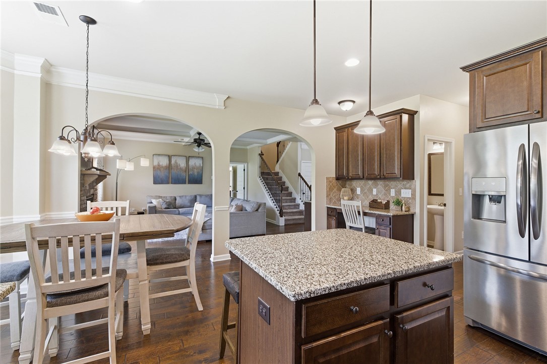 138 Buckland Drive Anderson, SC 29621 - Photo 18 of 49 This open concept space features a kitchen island, dining area, and inviting living room.