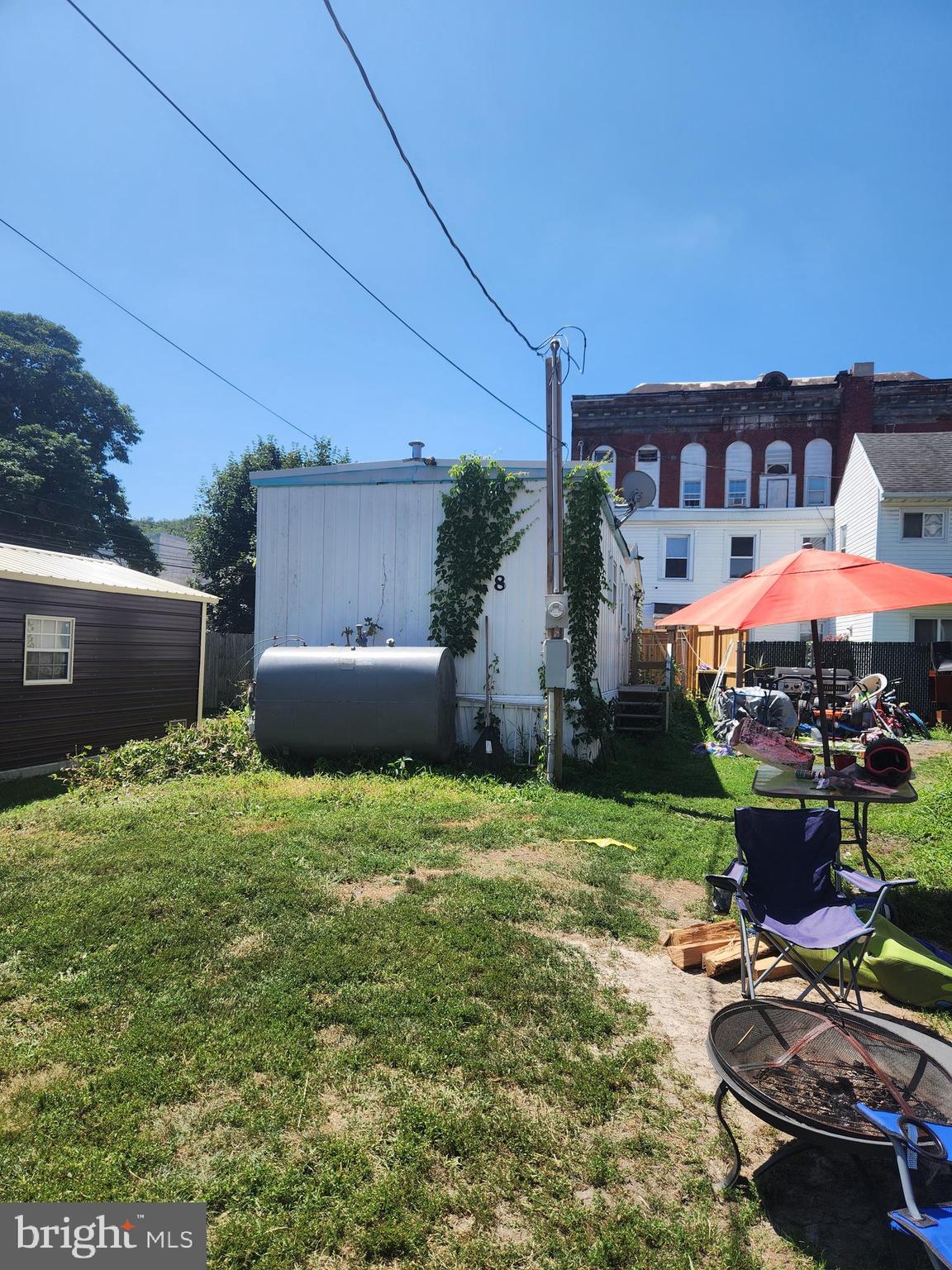 a backyard of a house with table and chairs