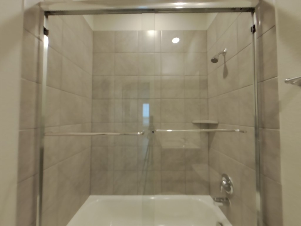 609 Foxtail Agave Street Leander, TX 78641 - Photo 13 of 29 a bathroom with a shower and a toilet